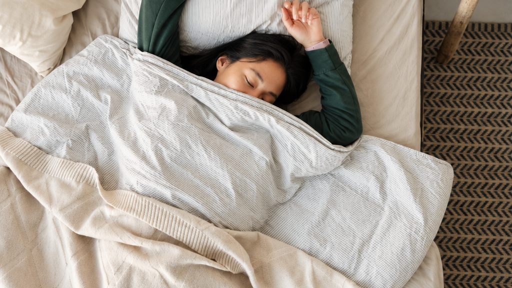 Personne endormie dans son lit, sous la couette